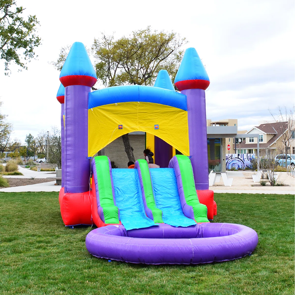 Jelly Bean bouncy castle with slides set up in a backyard